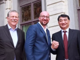 ZC Rubber's Shen Jinrong (right) shakes hands with Belgium prime minister Charles Michel, while Bekaert president Bert De Graeve looks on.