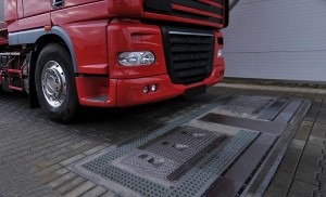  A truck prepares to drive over a fully-automated tire inspection system made by Ventech Systems