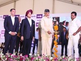 Andhra Pradesh chief minister lighting the lamp during the foundation stone laying ceremony of Apollo Tyres' facility in AP